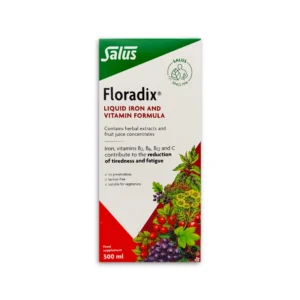 The image displays the packaging of Floradix Liquid Iron and Vitamin Formula. The design features a vibrant red background with a white triangular section in the top-left corner, where the product name, "Floradix," is prominently displayed. Below the name, it mentions the benefits: "Liquid iron and vitamin formula" and that it contains herbal extracts and fruit juice concentrates. The packaging also highlights the inclusion of iron, vitamins B2, B6, B12, and C, which help reduce tiredness and fatigue. The lower part of the design shows a colourful illustration of various fruits and plants, emphasizing the natural ingredients. The pack size is 500ml.