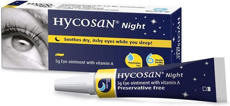 A product packaging for Hycosan Night Ointment. The box is predominantly white with blue and yellow accents. It features an image of a human eye on the upper half and specifies the product size as 5g. The box states that Hycosan Night soothes dry, itchy eyes while you sleep, is preservative-free, and has a 6-month usability period after opening. The image shows a box of Hycosan Night Ointment, an eye care product designed to provide overnight relief for dry eyes. The visual emphasis on nighttime use and soothing comfort is conveyed through the color scheme and eye imagery, making it relevant for individuals seeking relief during sleep.
