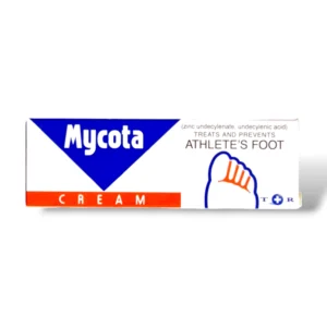 The image shows the packaging of Mycota Cream, a product designed to treat and prevent athlete's foot. The box is predominantly white with a blue triangular section on the top left, featuring the brand name "Mycota" in white text. Below the triangle, there is an orange band with the word "CREAM" written in white. To the right, the packaging mentions the active ingredients—zinc undecylenate and undecylenic acid. Additionally, there's a simple graphic of a foot with red markings on the toes, symbolising the area affected by athlete's foot.