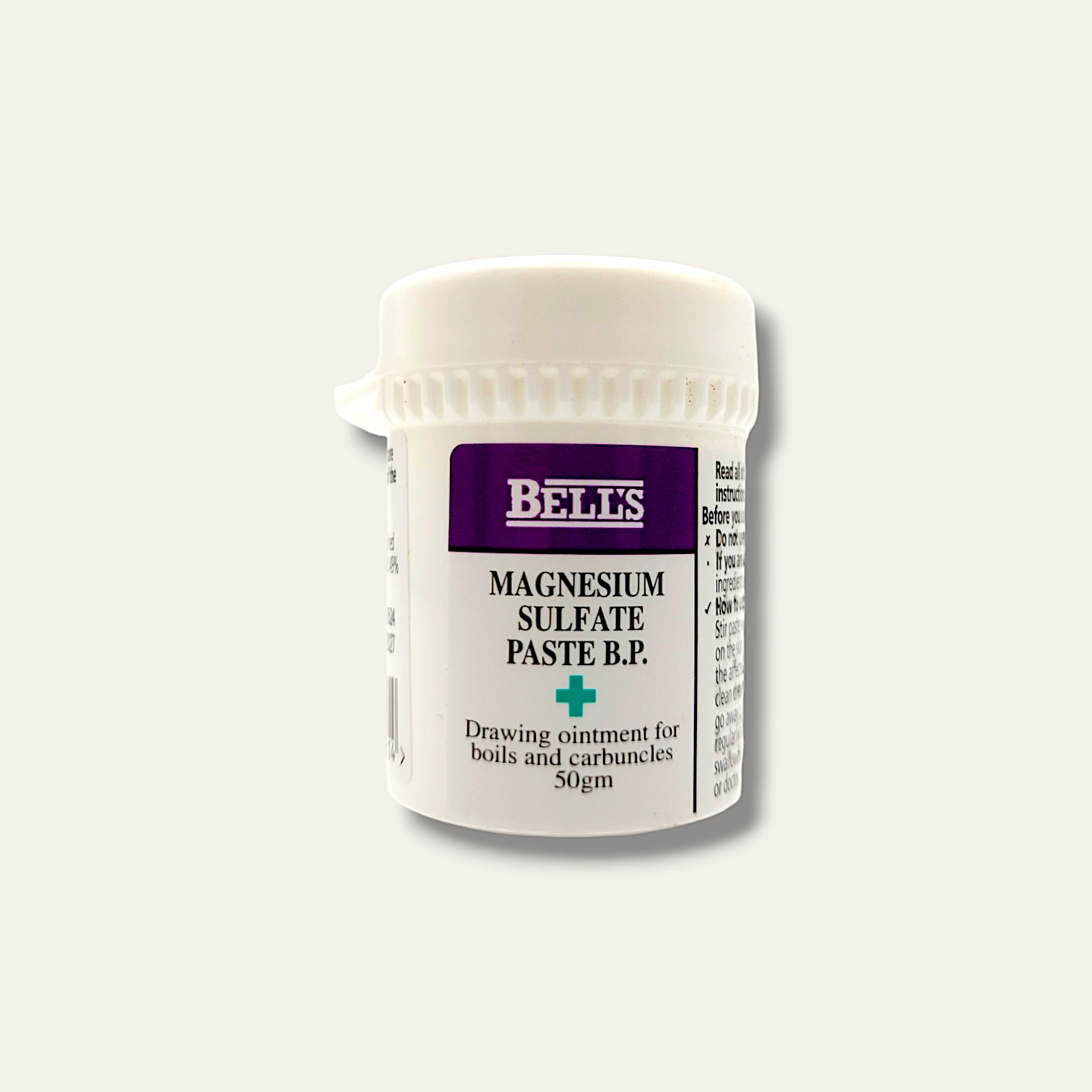 The image shows a small white plastic jar of "Bell's Magnesium Sulfate Paste B.P." with a purple label. The jar is labeled as "Drawing ointment for boils and carbuncles, 50gm." The cap is white, ribbed for easy gripping, and the jar is cylindrical with the product information printed on the front.