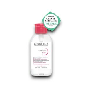 A bottle of Bioderma Sensibio H2O Micellar Water, 500 ml, with a pink cap, designed for sensitive skin. The label highlights its cleansing and soothing properties, suitable for face and eyes, alongside the "Woman & Home Clever Skincare Winner 2022" badge.