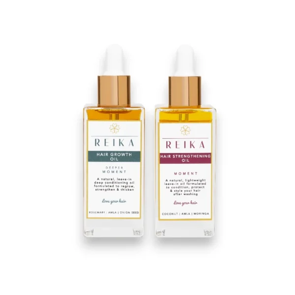 Two premium hair oil bottles displayed side by side. The left bottle is labeled 'REIKA Hair Growth Oil' featuring a green and gold design, highlighting 'Deeper Moment' with key ingredients such as Rosemary, Amla, and Onion Seed. The right bottle is labeled 'REIKA Hair Strengthening Oil' with a burgundy and gold design, emphasizing 'Moment' and ingredients like Coconut, Amla, and Moringa. Both bottles have golden caps and transparent containers showcasing golden-hued oil, set against a clean white background.